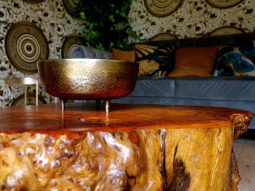 a bowl sitting on top of a wooden table at Deluxe 4 5 Bed Hot Tub Cinema Room 15 in Saffron Walden
