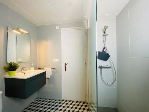 a bathroom with a shower and a sink and a shower at Apartamentos Aquarium in Roses