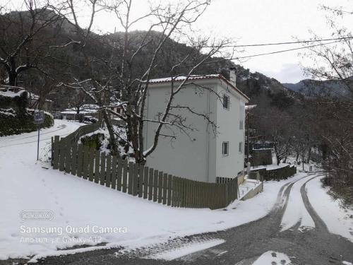 a white house with a fence in the snow at Villa Eva 2 