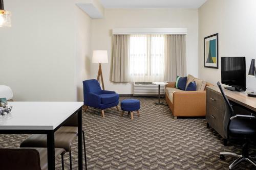a room with a living room with a couch and a tv at Residence Inn New Rochelle in New Rochelle