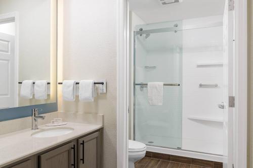 a bathroom with a shower and a sink and a toilet at Residence Inn New Rochelle in New Rochelle