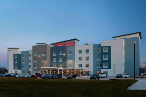 a large building with cars parked in a parking lot at TownePlace Suites by Marriott Austin Round Rock in Round Rock