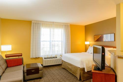 a hotel room with a bed and a tv at TownePlace Suites by Marriott Fort Meade National Business Park in Annapolis Junction