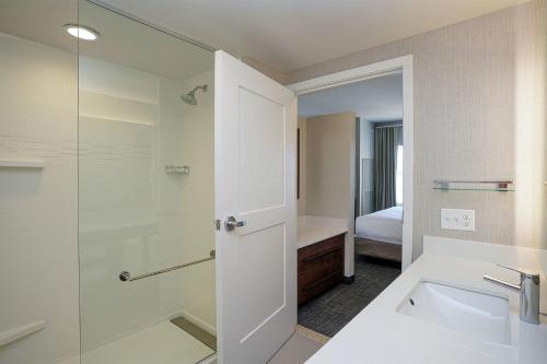 a bathroom with a shower and a sink and a toilet at Residence Inn by Marriott Colorado Springs First & Main in Colorado Springs