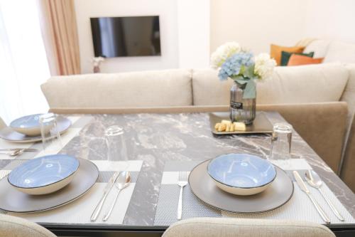 uma mesa de jantar com pratos azuis e brancos em Lindi's Apartment 4 7 em Tirana