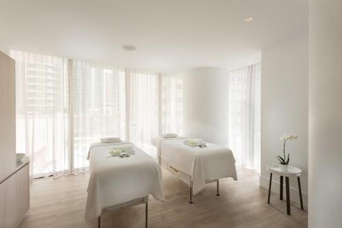 a white room with three tables with white sheets at The Westin Brisbane in Brisbane