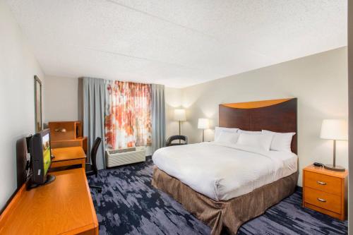 a hotel room with a bed and a flat screen tv at Fairfield Inn by Marriott Evansville East in Evansville
