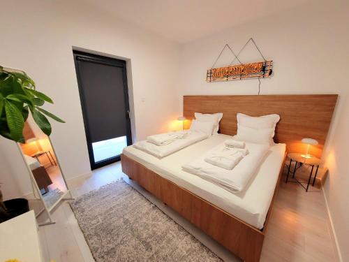 a bedroom with a large bed with white sheets and pillows at BAST 17 DOM duży parking , Mandoria , PTAK , 2 Sypialnie lub 1 sypialnia, taras , Autostrada A1, Kalinowskiego 17E WIFI in Łódź