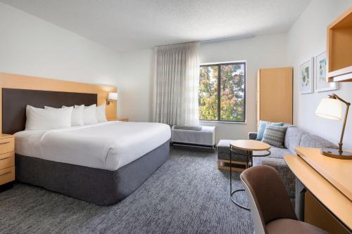 a hotel room with a bed and a couch at TownePlace Suites by Marriott York in York