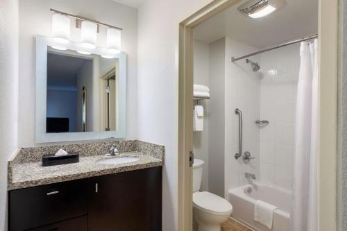 ein Badezimmer mit einem Waschbecken, einem WC und einem Spiegel in der Unterkunft TownePlace Suites by Marriott York in York