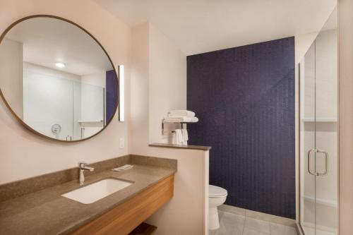 a bathroom with a sink and a mirror at Fairfield Inn & Suites by Marriott Fresno North/Shaw Avenue in Fresno