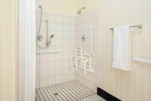 baño con ducha y suelo blanco y negro en Fairfield Inn & Suites by Marriott Selma Kingsburg, en Kingsburg