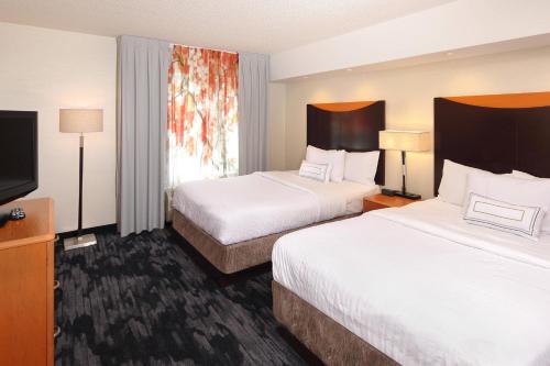 a hotel room with two beds and a flat screen tv at Fairfield Inn & Suites by Marriott Millville Vineland in Millville