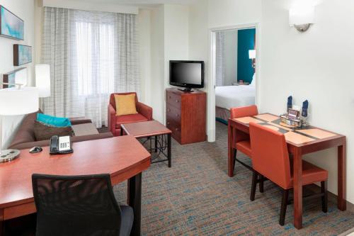 a hotel room with a living area and a room with a bed at Residence Inn by Marriott Chicago Lake Forest/Mettawa in Mettawa