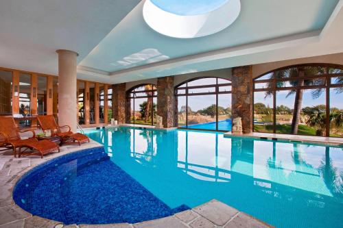 a swimming pool in a house with a large swimming pool at Sheraton Colonia Golf & Spa Resort in Colonia del Sacramento