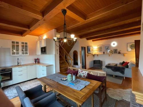 a kitchen and a living room with a wooden table at Cottage in Domaša. Chata na Domaši. in Bžany