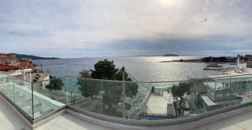 a balcony with a view of a body of water at Wide Blue Luxury Boutique Suites in Neos Marmaras