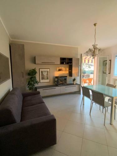a large living room with a couch and a table at Elena Apartment - View Lake - Private Garage in Bardolino