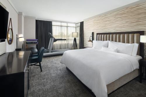 a hotel room with a large bed and a desk at The Westin Baltimore Washington Airport - BWI in Linthicum Heights
