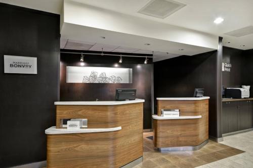 a lobby with a desk with a laptop on it at Courtyard by Marriott Dalton in Dalton