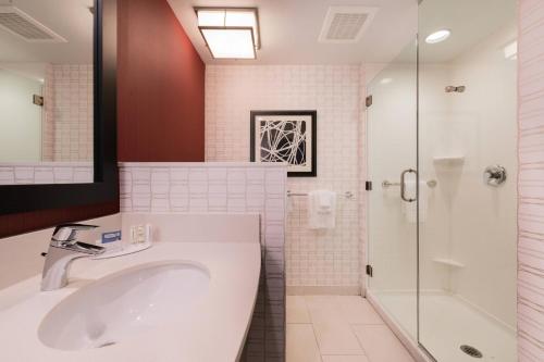 a bathroom with a sink and a shower at Courtyard by Marriott Wilmington Downtown/Historic District in Wilmington