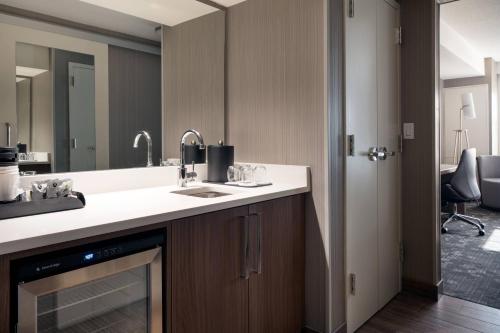 a bathroom with a sink and a mirror at Courtyard Denver Airport at Gateway Park in Aurora