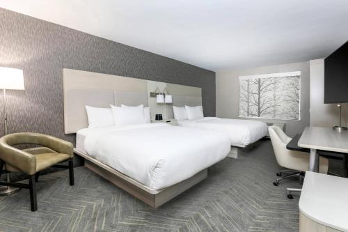 a hotel room with two beds and a desk at Fairfield by Marriott Inn & Suites Amarillo Central in Amarillo