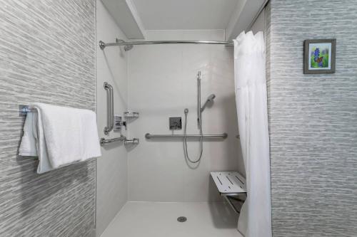 a white bathroom with a shower and a sink at Fairfield by Marriott Inn & Suites Amarillo Central in Amarillo