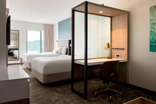 a hotel room with two beds and a desk at SpringHill Suites by Marriott Tampa Suncoast Parkway in Land O' Lakes