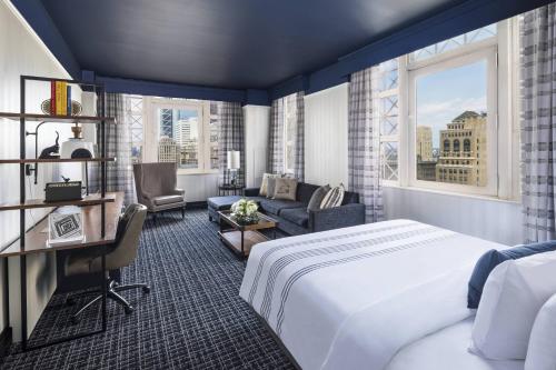 a hotel room with a large bed and a desk at The Notary Hotel, Philadelphia, Autograph Collection in Philadelphia