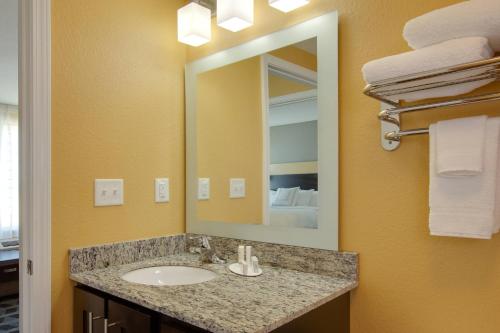 a bathroom with a sink and a mirror at TownePlace Suites by Marriott Corpus Christi Portland in Portland