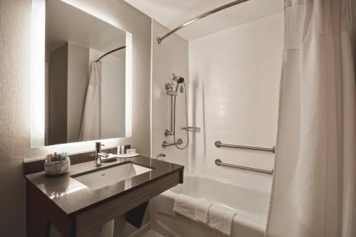 a bathroom with a sink and a shower at SpringHill Suites by Marriott Atlanta Kennesaw in Kennesaw