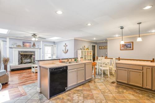 an open kitchen with a living room and a fireplace at SML Ski School in Moneta