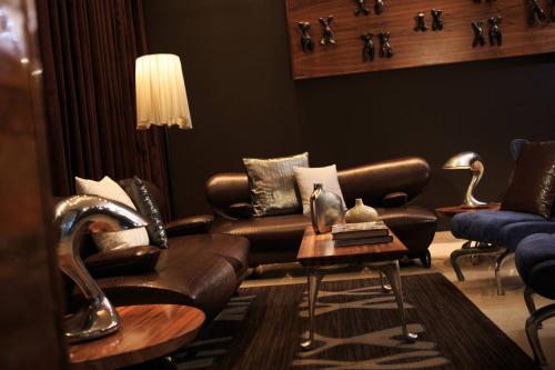 a living room with leather couches and a table at Renaissance New York Times Square Hotel in New York