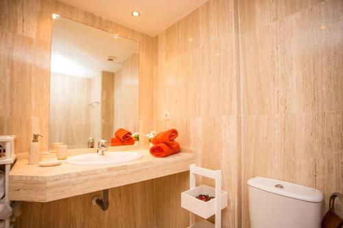 a bathroom with a sink and a mirror and a toilet at Los Lagos de Santa Maria Golf in Marbella