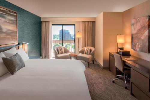 a hotel room with a bed and a desk at Denver Marriott Tech Center in Greenwood Village