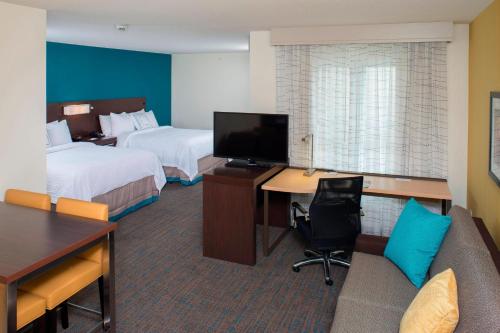 a hotel room with two beds and a desk with a computer at Residence Inn by Marriott Albany Clifton Park in Clifton Park