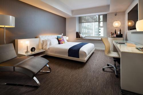 a hotel room with a bed and a desk at W Hollywood in Los Angeles