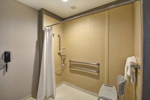 a bathroom with a shower with a shower curtain at SpringHill Suites by Marriott Indianapolis Airport/Plainfield in Plainfield