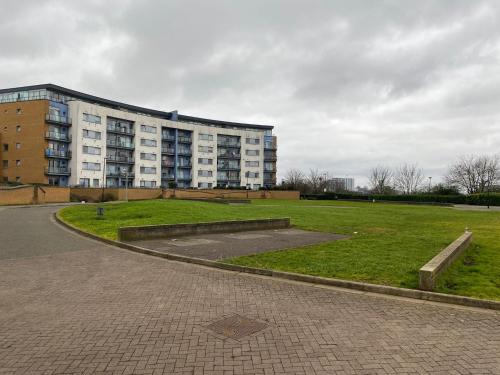 a large building with a park in front of it at David’s apartment in London