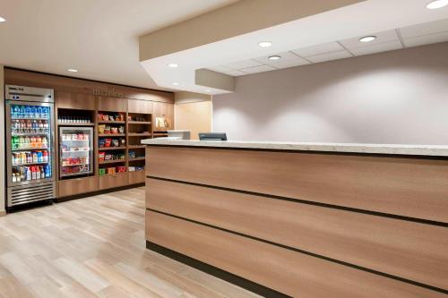 a cashier counter in a store with a drink refrigerator at Residence Inn by Marriott Tampa at USF/Medical Center in Tampa