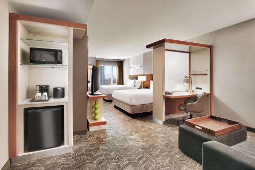 a hotel room with a bed and a television at SpringHill Suites by Marriott Las Vegas Convention Center in Las Vegas