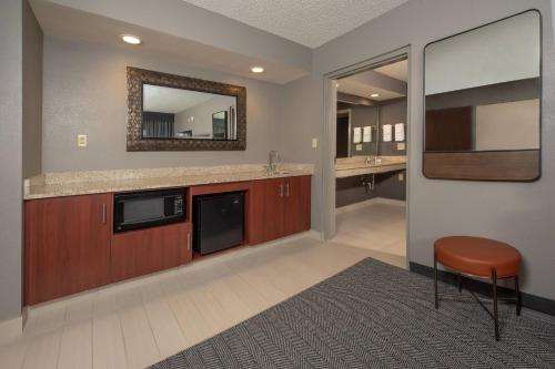 a large bathroom with a sink and a mirror at Courtyard by Marriott Frederick in Frederick