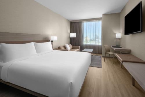 a large white bed in a hotel room at AC Hotel by Marriott Miami Dadeland in Miami
