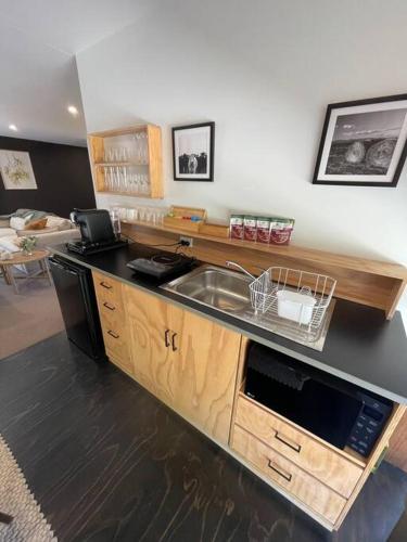 a kitchen with a sink and a counter top at Yellow Door Villa in Barwon Heads