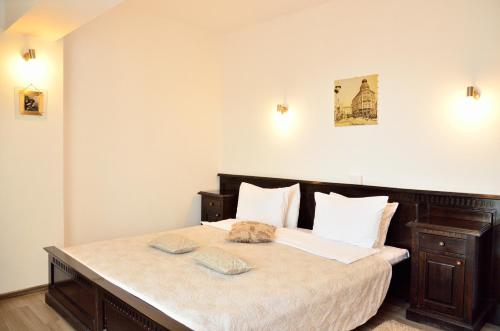a bedroom with a large bed with two towels on it at Hotel Belleville in Iaşi