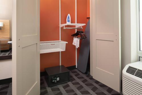 a room with an orange wall and a room with a door at TownePlace Suites by Marriott San Diego Downtown in San Diego