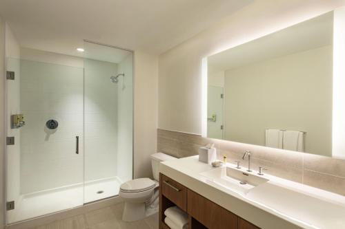 a bathroom with a sink and a toilet and a mirror at Element Philadelphia Downtown in Philadelphia