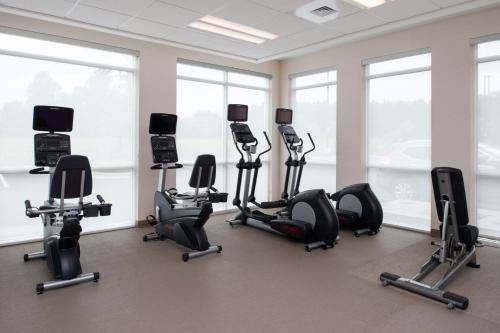 a gym with a bunch of exercise equipment in a room at SpringHill Suites by Marriott Greensboro Airport in Greensboro