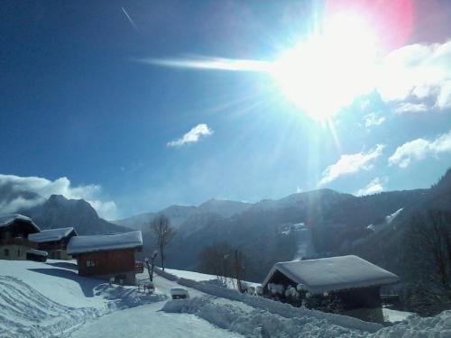 a snow covered mountain with the sun in the sky at Chalet Titlis in Bernex